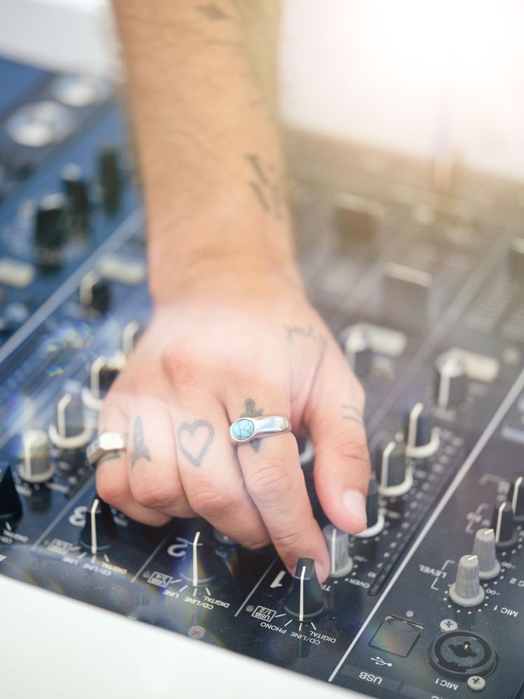 Crop man using professional DJ mixing console