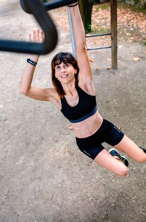 Woman doing monkey exercises on rings