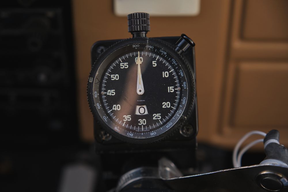 Cockpit stopwatch with button and scales in airplane