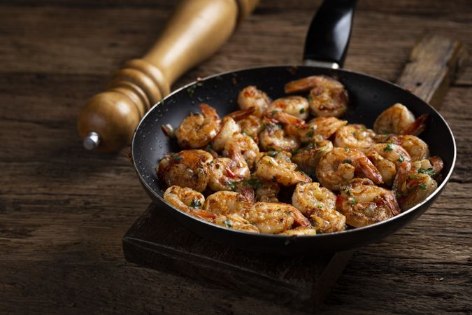 Delicious grilled prawns on wooden background.
