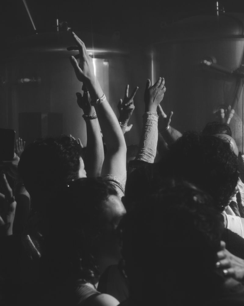 London, England, United Kingdom - Nov 9, 2022: People with hands up on the dance floor, vertical