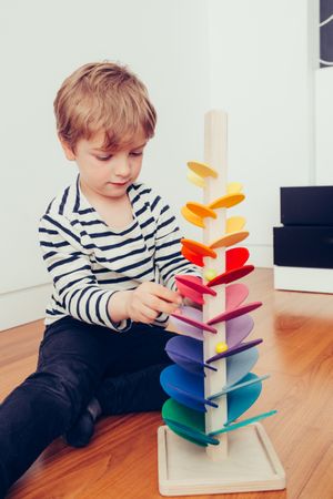 Boy playing with wooden construction pieces