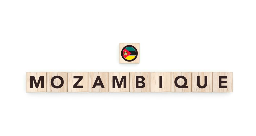 Wooden blocks bearing the name and flag of Mozambique. Mozambican and South African Culture, national identity, travel, and geography in a copy space design.