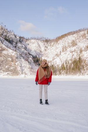 Frozen woman wrapped in scarf on winter day