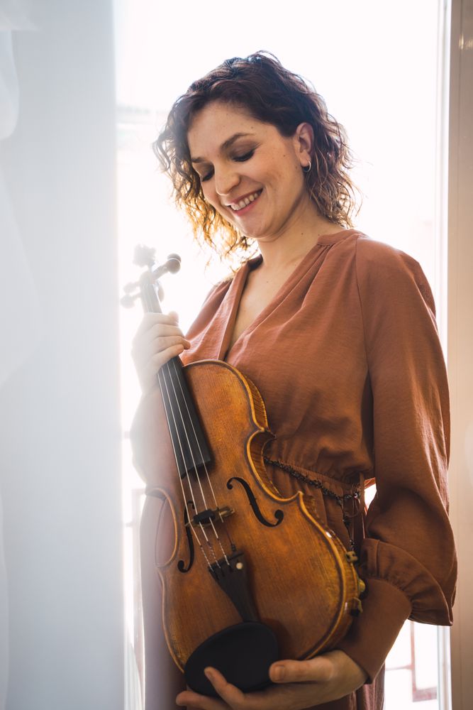 Young smiling woman with violin