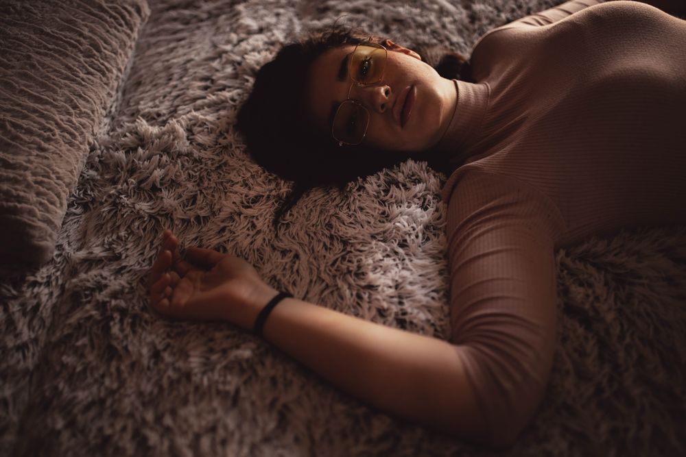 Young woman lying on bed