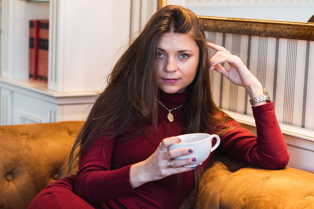 Woman with cup of coffee on the couch