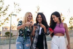Women walking in the street using smartphones