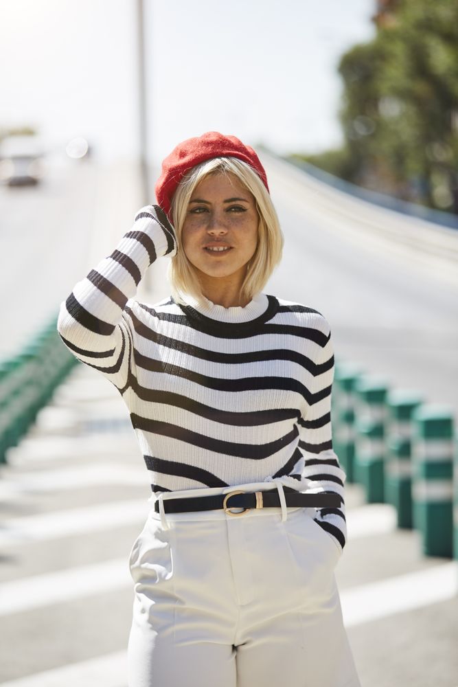 female in red beret outdoors