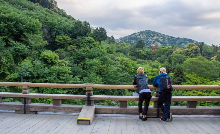 Japan - May, 10 2013: Anonymous persons looking at river and town