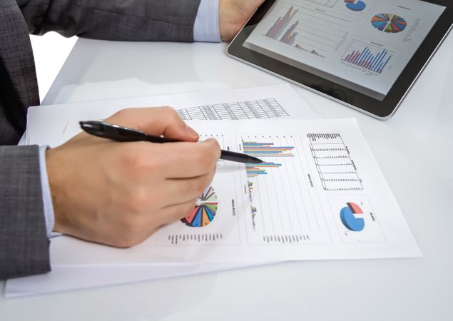 Businessman reviewing documents in digital tablet