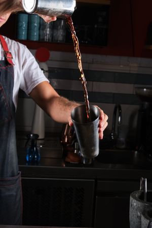 Unrecognizable man mixing drink in bar