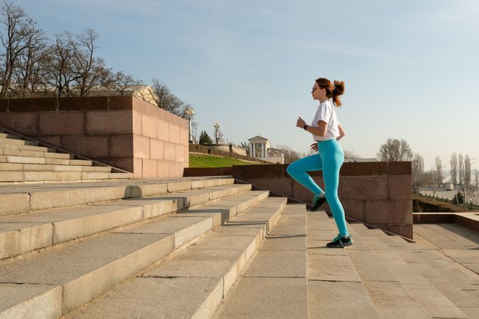 Young woman jogging on city streets
