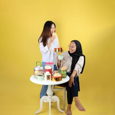 Two Cousin Eating Indonesian Traitional Snack
