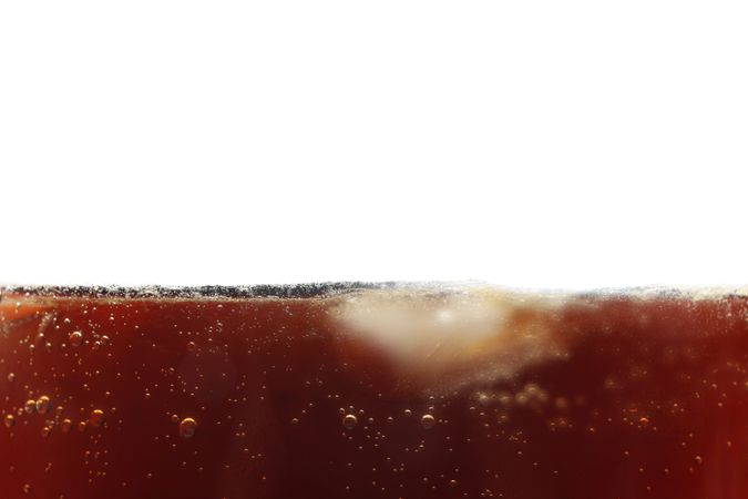 Side view background of cold cola with ice, isolated