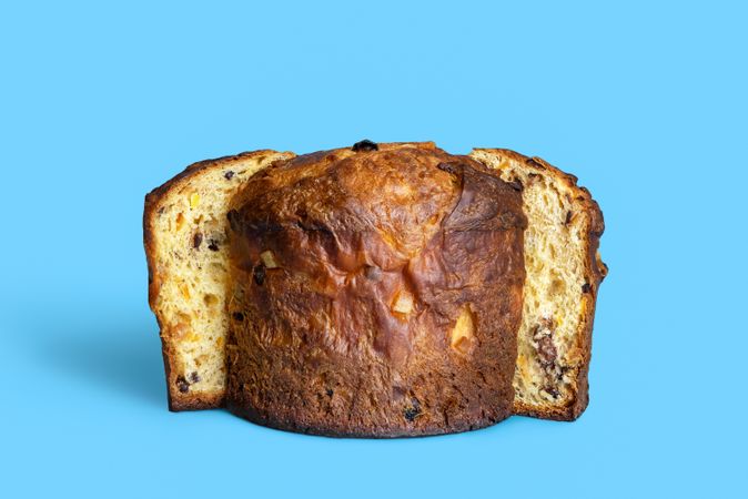 Chunks of homemade panettone isolated on a blue background