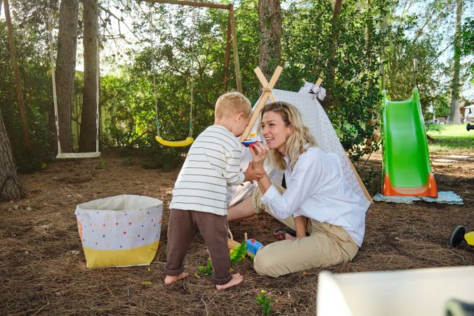 Mother and son playing with toys in playground