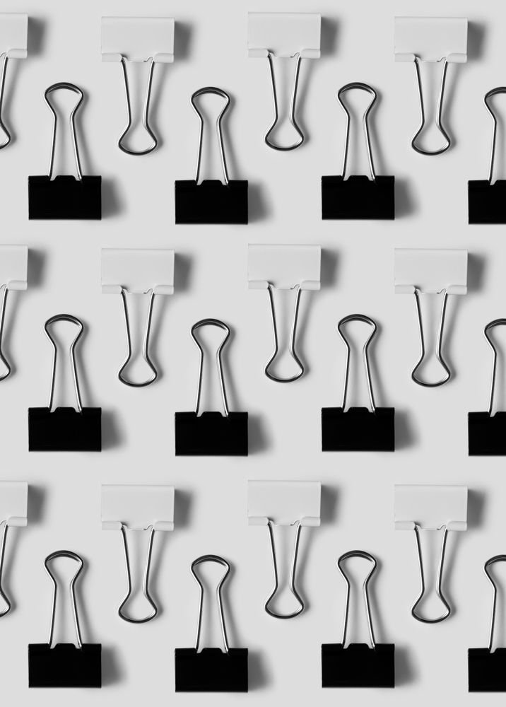 Binder clips on light background