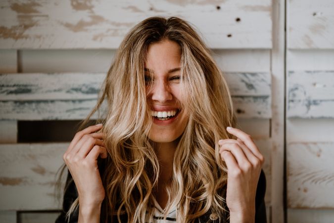 Woman clutching head and looking at camera