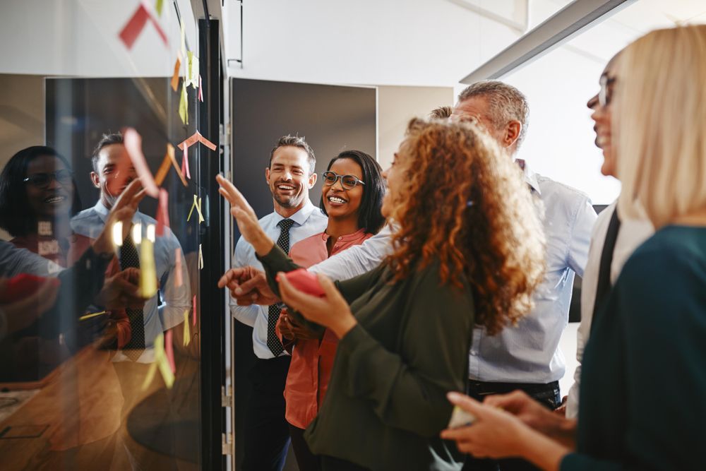 Group of people working with sticky notes in office