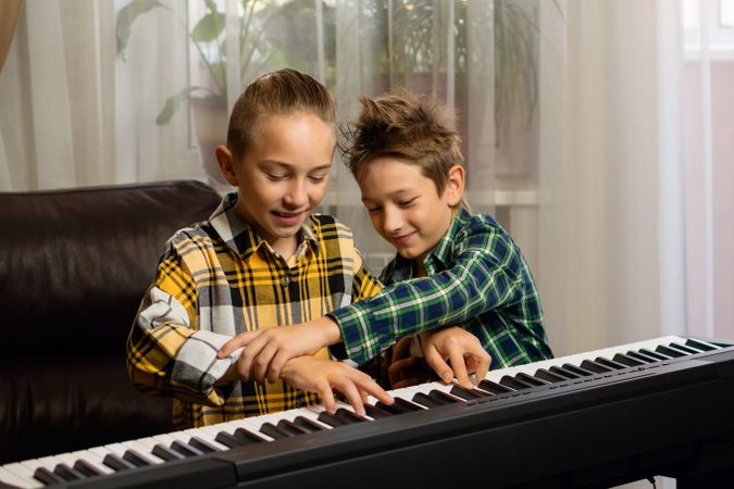 Joyful Siblings Sharing Piano