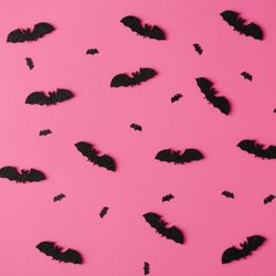Pattern made of bats on pink background