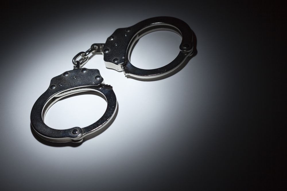 Abstract Pair of Handcuffs Under Spot Light - Text Room