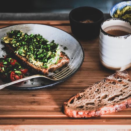 Avocado toast on sourdough bread, with cherry tomatoes  coffee, toast, bowl, square crop