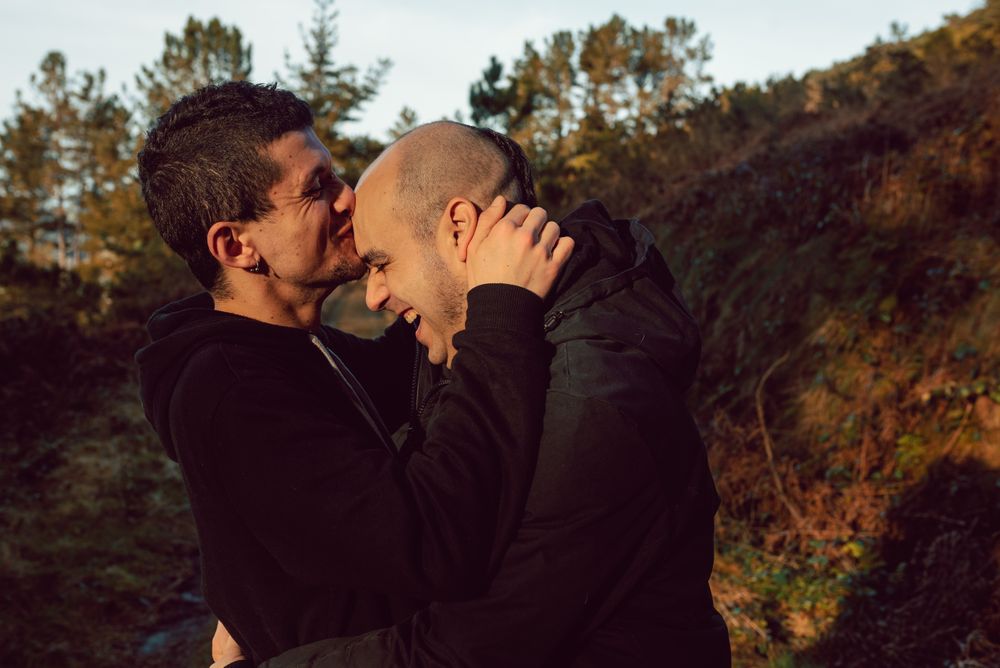 laughing men hugging in countryside road