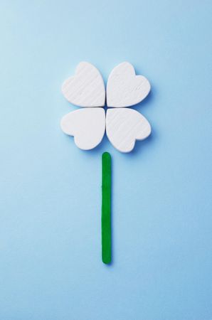 Hearts arranged as clover over light blue background