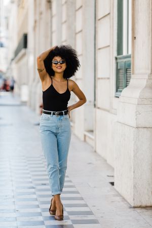 Cheerful Black female in dark sunglasses