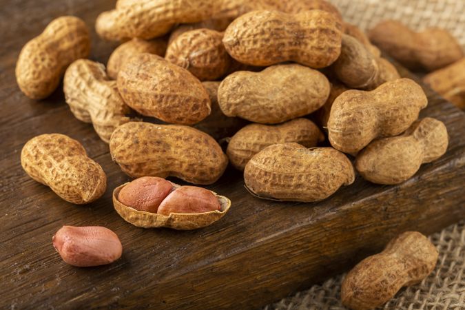 Dry peanut on the wooden background.