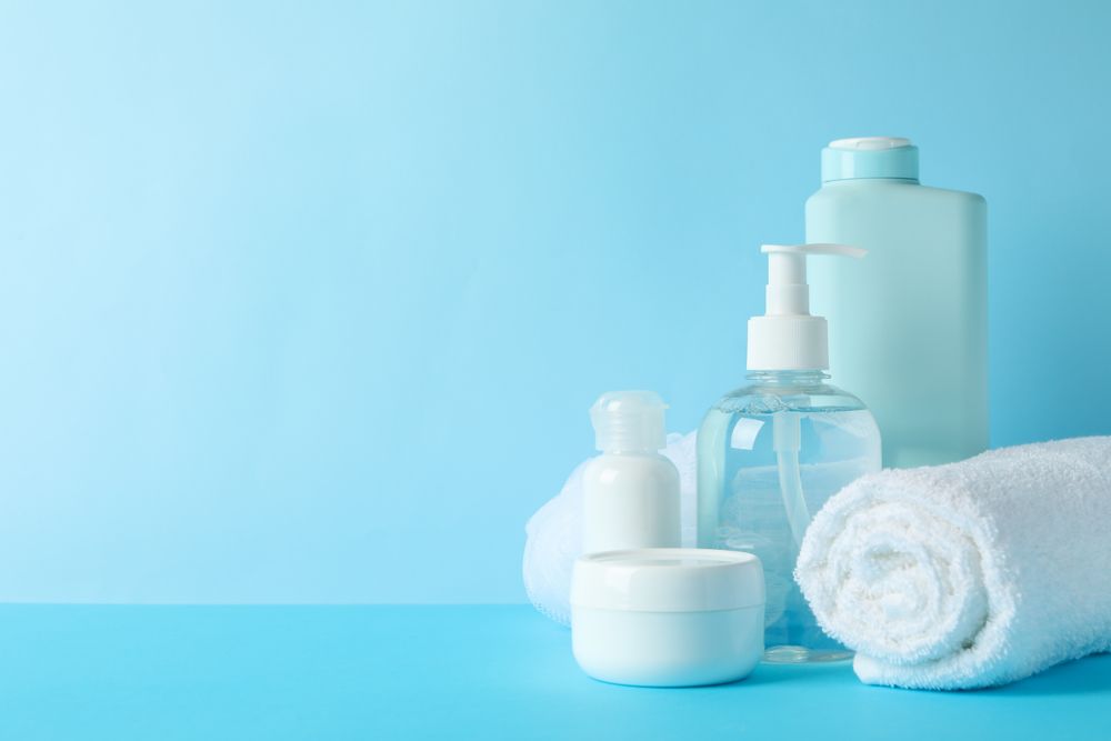 Body care products on blue background. Personal hygiene