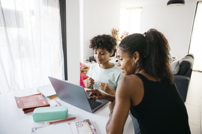 Girl doing her homework with mother