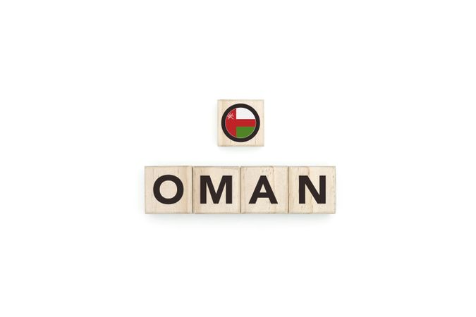 Wooden blocks bearing the name and flag of Oman.