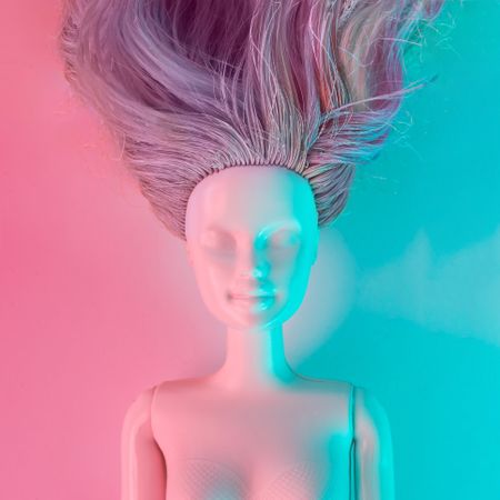 Doll painted in light-colored paint with vibrant bold gradient holographic lights