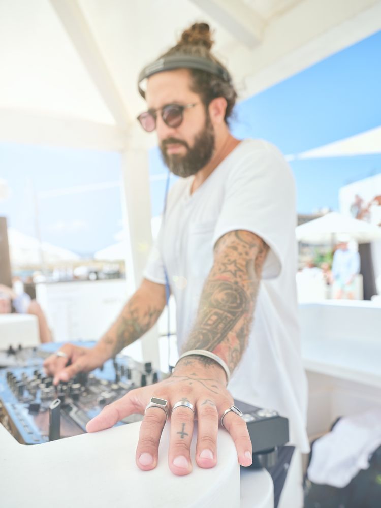 Cool DJ working with equipment while playing music