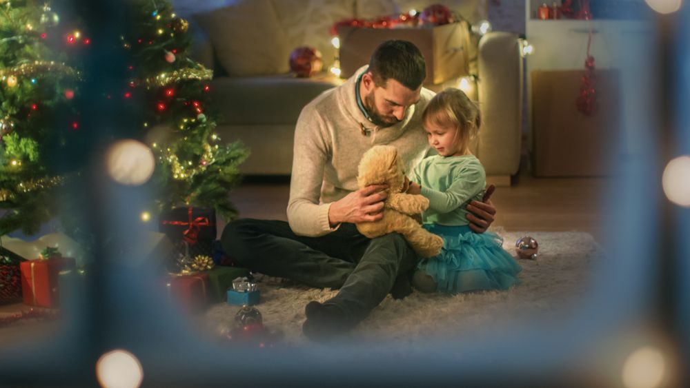 Sitting Under Christmas Three  Father and Daughter Play with Plush Bear.