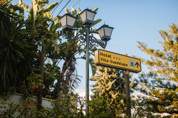 Sign and lamppost near hotel