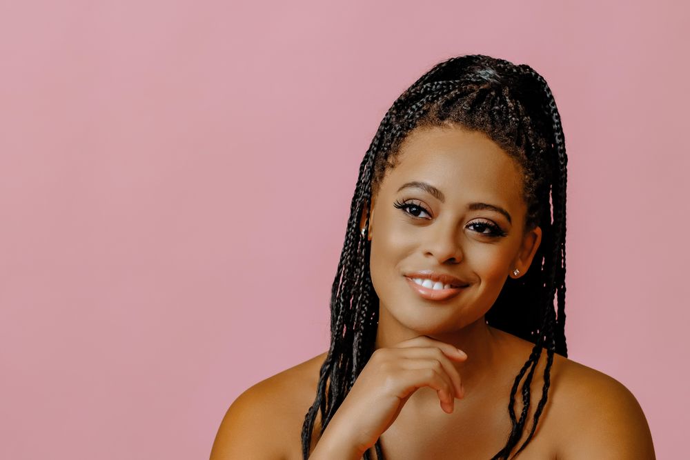 Relaxed female looking at camera in pink studio shoot