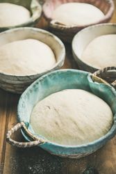 Multiple baskets of bread dough