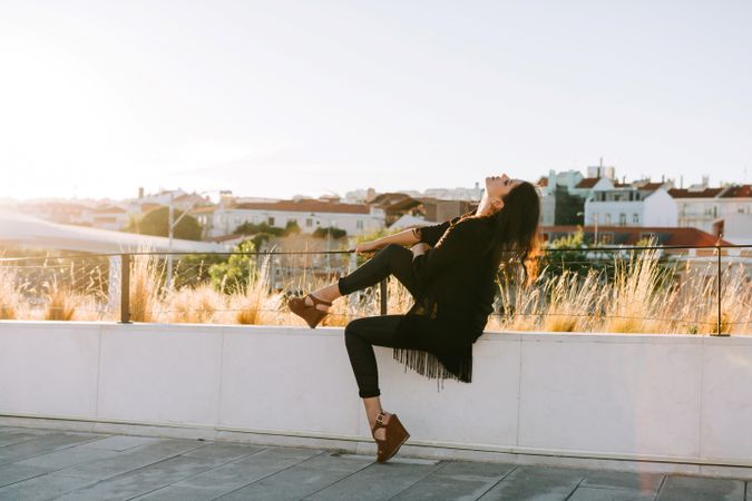 Trendy female standing on urban background