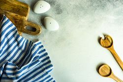 Modern salt and pepper shaker with wooden spoons on kitchen counter with copy space