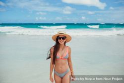 Woman in pink and gray bikini standing on beach 4mB1Xb