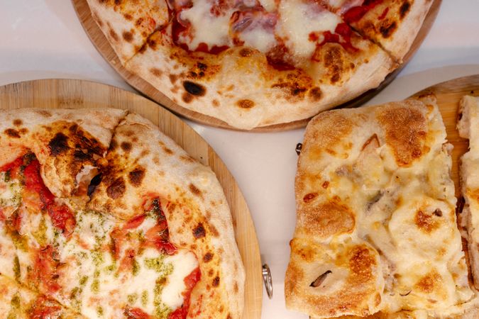Overhead portrait of several pizzas