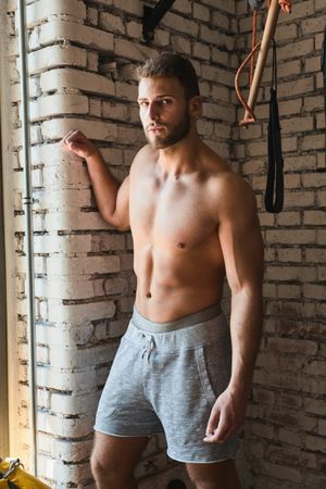 Muscular man posing in gym