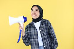 Excited Young Asian Muslim Woman Shouting using Megaphone