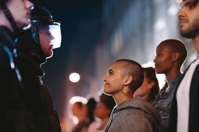 Woman staring at the policeman and smiling during a rally