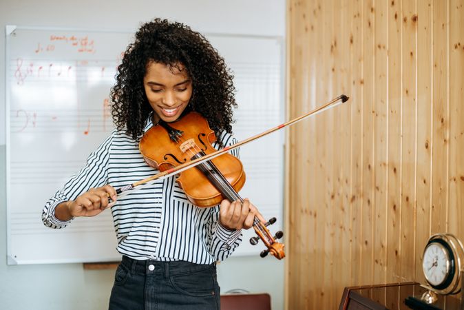 Woman playing violin in studio