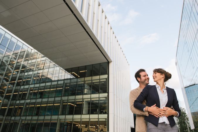 Businesspeople couple outside contemporary building
